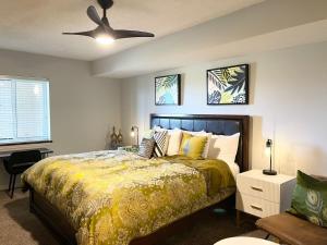 a bedroom with a bed and a ceiling fan at Huge 15000sf Pool Modern Studio at Barefoot Resort in Myrtle Beach