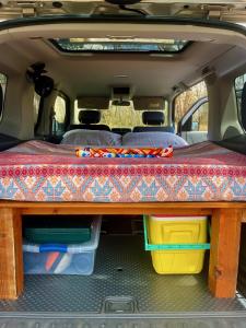 a table in the back of a van with a table at Go Camp Maui-Exploring Maui in a Campervan in Ah Fong Village