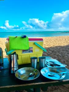 a table with plates of food on a beach at Go Camp Maui-Exploring Maui in a Campervan in Ah Fong Village