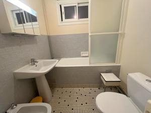 a bathroom with a sink and a tub and a toilet at Studio Les Sables-d'Olonne, 1 pièce, 2 personnes - FR-1-197-265 in Les Sables-d'Olonne