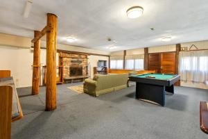 a living room with a pool table in it at Front Lodge at Rainier Lodge (0.4 miles from entrance) in Ashford