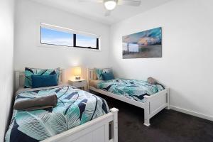 a bedroom with two beds and a window at Raven West House I Corporate or Holiday in Geelong West