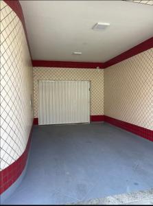 an empty room with red and white tiled walls at Pousada Coqueiros in Cabo Frio