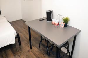 a table with a coffee maker and two mugs on it at mySTAY Hotel BGC East in Manila