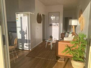 a living room with a couch and a table at Terrigal Coastal Casa in Wamberal