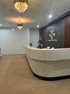 a lobby with a reception desk in a building at TZ SATELLITE HOTEL, Kota Bharu in Kota Bharu