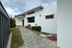 una casa blanca con un camino delante de ella en Exquisite Private Villa, en Las Terrenas
