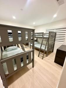 a room with two bunk beds and a bench at Qazaq Hostel in Los Angeles