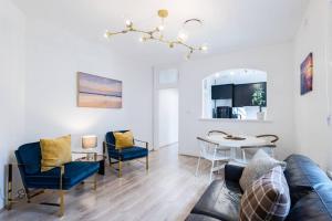 a living room with a couch and a table at Waterfront - KING Bed Suite @ Rocks Sydney #10A in Sydney