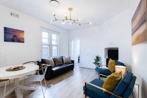 a living room with a couch and a table at Waterfront - KING Bed Suite @ Rocks Sydney #10A in Sydney
