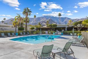 a pool with chairs and mountains in the background at Private Pool & Mountain Views! in Palm Springs