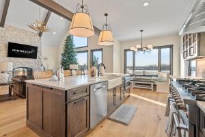 a kitchen with a large island and a kitchen with a stove at The Belle Retreat in Center City