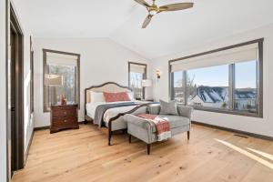 a bedroom with a bed and a chair and windows at The Belle Retreat in Center City