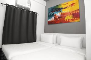 Postel nebo postele na pokoji v ubytování mySTAY Hotel BGC South