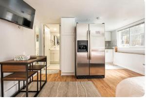 a kitchen with a stainless steel refrigerator and a table at Resort style home living in Delta