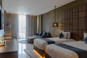 Postel nebo postele na pokoji v ubytování Wyndham Tamansari Jivva Resort Bali