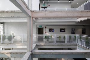 a building with a balcony with plants on it at C'HOUSE Bangkok in Pom Prap