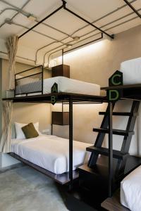 a room with two bunk beds in a room at C'HOUSE Bangkok in Pom Prap