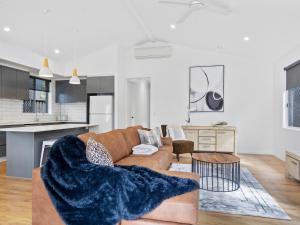 a living room and kitchen with a brown couch at 4BR Luxe Home, Miami Gold Coast in Gold Coast