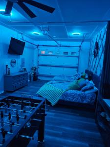 a bedroom with a bed with blue lights on it at Hidden Gem Guest House in Panama City Beach
