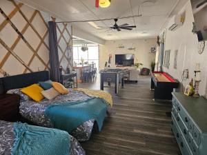 a room with two beds and a living room at Hidden Gem Guest House in Panama City Beach