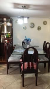 a dining room with a table with chairs and a dining room at CASA LESLY in Cuenca