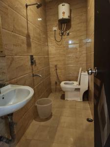 Hotel New City Lite في نيودلهي: حمام مع مرحاض ومغسلة