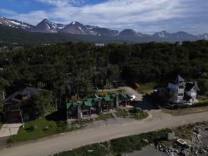 an aerial view of a house with mountains in the background at COSTA DE LOS PAJAROS in Ushuaia +16 photos