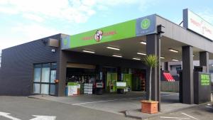 a gas station with a sign on the side of it at San Remo Hotel Motel in San Remo +1 photo