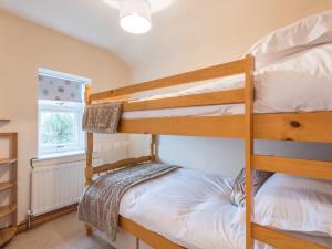 two bunk beds in a room with a window at 3 Bed in Gosforth SZ064 in Gosforth