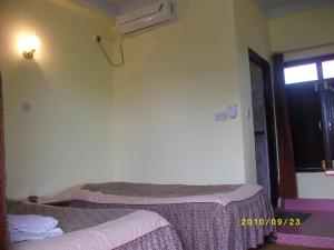 Rúm í herbergi á Siddhartha Guest House