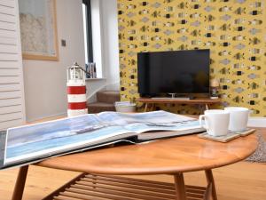 a coffee table with a book on top of it at 3 Bed in Ilfracombe 42432 in Ilfracombe