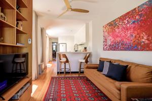 a living room with a couch and a table at Charming 3-Bedroom Terrace in the Heart of Glebe in Sydney