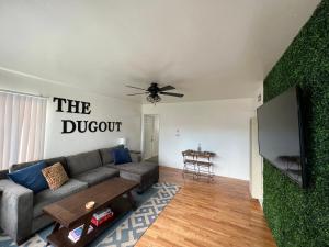a living room with a couch and a flat screen tv at The Dugout in San Diego
