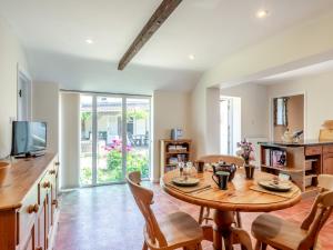 a kitchen and living room with a wooden table and chairs at 2 Bed in Reepham 37016 in Cawston