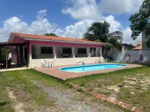 a house with a swimming pool in front of it at Casa em Porto, piscina e 5 qrts in Porto De Galinhas
