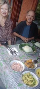 a man and woman sitting at a table with plates of food at The Diary in Ella