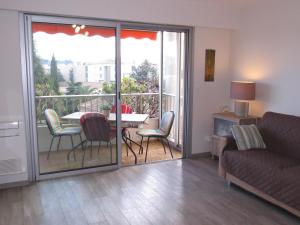 ein Wohnzimmer mit einem Balkon mit einem Tisch und Stühlen in der Unterkunft Appartement Sainte-Maxime, 2 pièces, 4 personnes - FR-1-780-63 in Sainte-Maxime