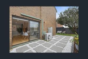 a view of a patio with a window and a house at 3 Bedroom Home in Cheltenham in Cheltenham