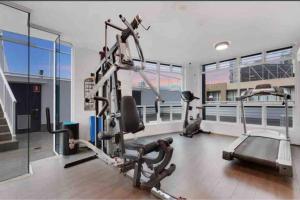a gym with a treadmill and a elliptical machine at South Brisbane modern apartment in Brisbane