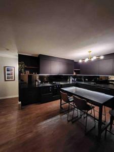 a large kitchen with a table and chairs in it at South Brisbane modern apartment in Brisbane +18 photos