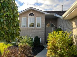 a house with a gray door and windows at Cozy Arbour Vacation Home - 8 beds 5 rooms in Kingston
