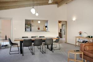 a living room with a dining room table and chairs at Seven Views I Pool Table n Water Views in Clifton Springs
