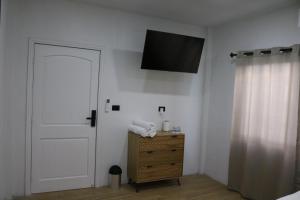 a bedroom with a door and a television on the wall at Casa Francisca 