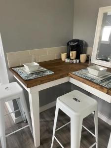 a kitchen with a counter with two stools and a counter top at ATX Tiny House in Austin