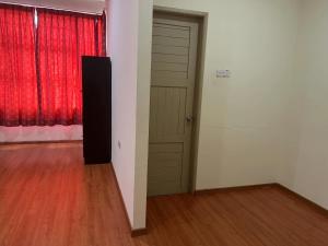 an empty room with a door and a red curtain at 1717 Bintulu Homestay 1 in Bintulu
