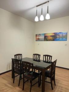a dining room with a table and four chairs at 1717 Bintulu Homestay 1 in Bintulu