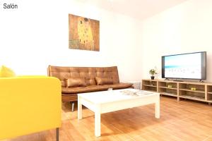 a living room with a couch and a coffee table at 2 bedrooms appartement with wifi at Las Palmas de Gran Canaria in Las Palmas de Gran Canaria