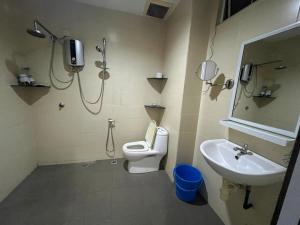 a bathroom with a shower and a toilet and a sink at Mega Homestay in Butterworth