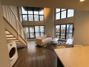 a living room with a washer and dryer in a building at LUXURY LOFT IN DOWNTOWN VANCOUVER in Vancouver